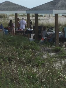 Rescuers stop to regroup at a picnic table at Range Light Beach while searching for the missing swimmer. Photo by Andrew Sanger